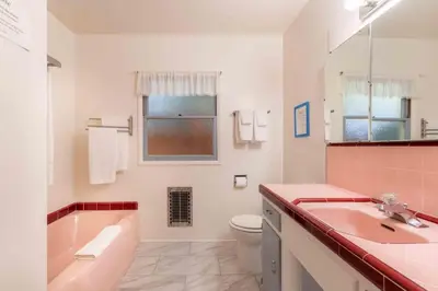 a bathroom with a tub and a toilet and a sink at PuertAzul in San Diego