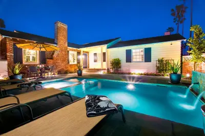 a swimming pool in the backyard of a home at night at Las Palmas Escape in San Diego