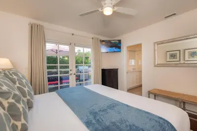 a bedroom with a bed with a ceiling fan at Las Palmas Escape in San Diego