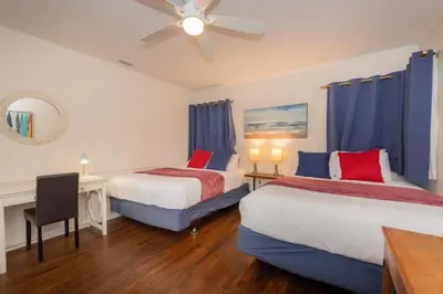 a hotel room with two beds and a ceiling fan at Las Palmas Escape in San Diego