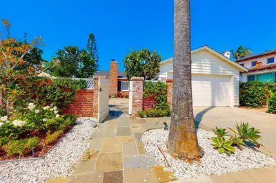 a palm tree in front of a house at Las Palmas Escape in San Diego