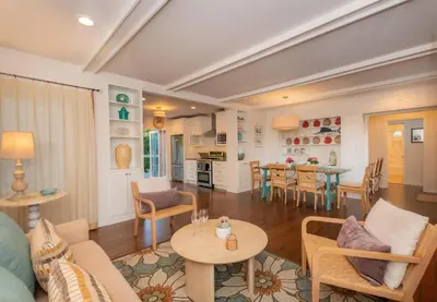 a living room and kitchen with a table and chairs at Las Palmas Escape in San Diego