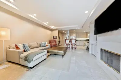 a living room with a couch and a flat screen tv at Village and Views in San Diego