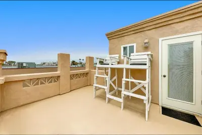 a balcony with a desk on top of a building at Village and Views in San Diego