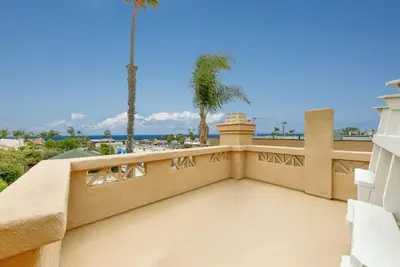 a balcony of a house with palm trees at Village and Views in San Diego