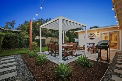 a pavilion with a table and a grill in a backyard at Family Oasis with Hot Tub and Dedicated Workspace in San Diego