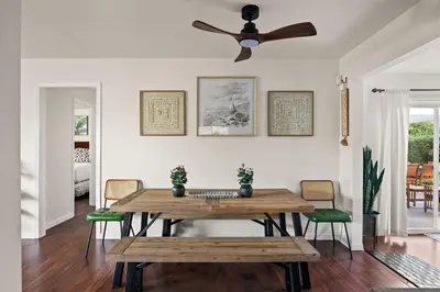 a dining room with a wooden table and a ceiling fan at Family Oasis with Hot Tub and Dedicated Workspace in San Diego