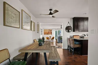 a dining room and kitchen with a wooden table at Family Oasis with Hot Tub and Dedicated Workspace in San Diego