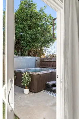 an open door to a backyard with a hot tub at Family Oasis with Hot Tub and Dedicated Workspace in San Diego