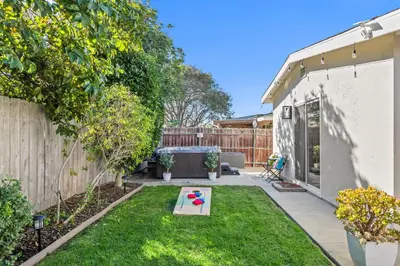a backyard with a small garden with a toy in the grass at Family Oasis with Hot Tub and Dedicated Workspace in San Diego