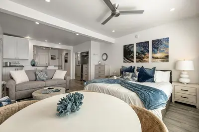 a bedroom with two beds and a living room at Ocean VIEWS! Steps from Victoria Beach, Lux Design in Laguna Beach