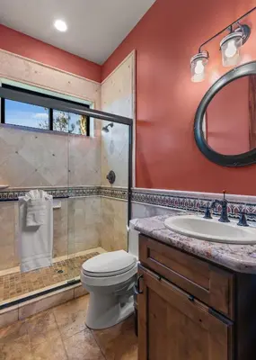 a bathroom with a toilet and a shower and a sink at Timeless Spanish Villa with Panoramic Ocean Views in San Diego