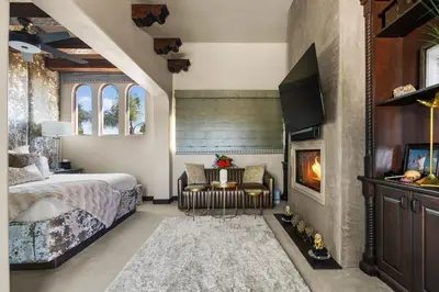 a bedroom with a bed and a fireplace at Timeless Spanish Villa with Panoramic Ocean Views in San Diego
