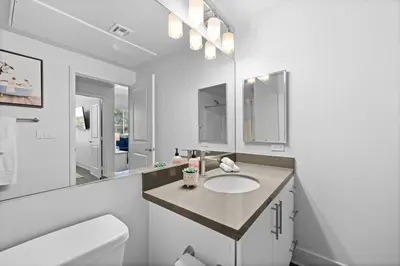 a bathroom with a sink and a mirror at King Bed, Pool, Hot Tub, Arcade Room, Gym, Parking in San Diego