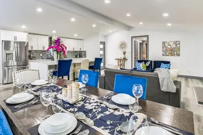 a dining room with a table and blue chairs at Mission Valley Home 5 Mi to SDSU Campus in San Diego