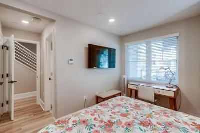 a bedroom with a bed and a desk and a window at Steps 2 Ocean & Bay Luxury Belmont Park Dining in San Diego