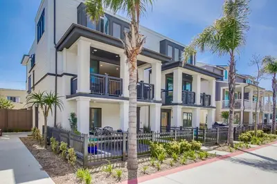 a large house with palm trees in front of it at Steps 2 Ocean & Bay Luxury Belmont Park Dining in San Diego