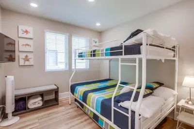 a bedroom with two bunk beds in a room at Steps 2 Ocean & Bay Luxury Belmont Park Dining in San Diego