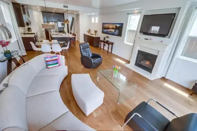 a living room with a couch and a fireplace at Rooftop Patio Hot Tub AC Beach & Bay Views in San Diego