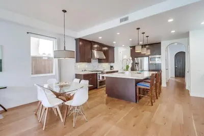 a kitchen with a table and chairs and a dining room at Rooftop Patio Hot Tub AC Beach & Bay Views in San Diego