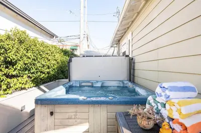 a hot tub sitting on the side of a house at Charming Mid-Century Craftsman, Hot Tub with Serene Yard in San Diego