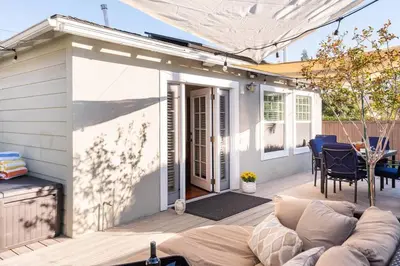 a patio with a couch on a wooden deck at Charming Mid-Century Craftsman, Hot Tub with Serene Yard in San Diego