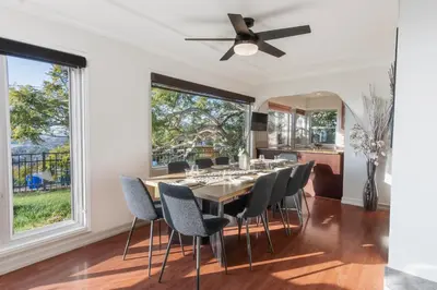 a dining room with a table and chairs and a ceiling fan at Family-Friendly Bay Views, Game Room, Hot Tub! in San Diego
