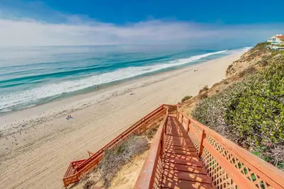 a view of a beach with a wooden boardwalk at Ocean Views Moonlight Beach Ocean Deck Pool Hot Tub in Encinitas