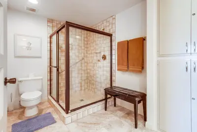 a bathroom with a shower and a toilet at Ocean Views Moonlight Beach Ocean Deck Pool Hot Tub in Encinitas