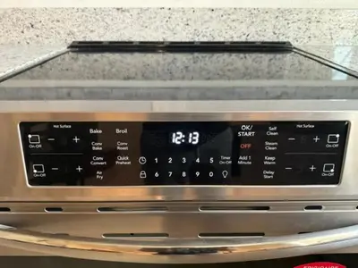 a close up of a microwave oven with a digital clock at Elegant Retreat with Private Luxurious Gen Suite in Menifee
