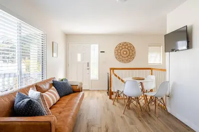 a living room with a couch and a table at Beacons Beach Cottage in Encinitas