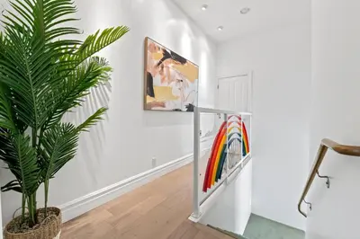 a hallway with a plant and a painting on the wall at Above the Clouds 17acre Gated Hilltop Estate in Fallbrook