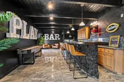 a bar with yellow stools and a bar with a restaurant at Above the Clouds 17acre Gated Hilltop Estate in Fallbrook
