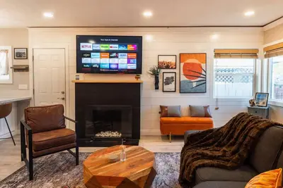 a living room with a fireplace and a tv at SDSU and Downtown Less Than 10 Min, Game Room, and Fire Pit in La Mesa