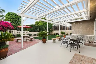 an outdoor patio with a pergola and a table and chairs at Hills Hideaway by CoastVH - Luxury Midtown 3br in San Diego