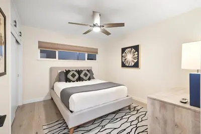 a bedroom with a bed and a ceiling fan at Hills Hideaway by CoastVH - Luxury Midtown 3br in San Diego