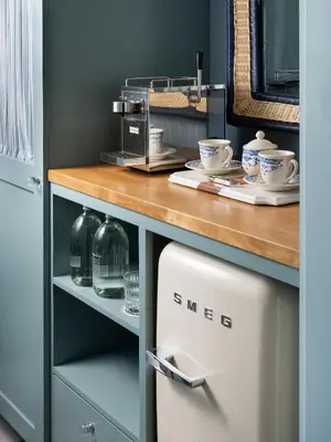 a kitchen with a white refrigerator under a counter at Le Petit Pali Laguna Beach in Laguna Beach