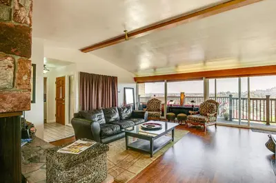 a living room with a couch and a table at Mt Nebo Oasis in La Mesa with Wraparound Deck in La Mesa