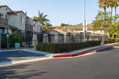 a street in a villa with a fence and trees at Redecorated - Serene- Legoland- Family-Friendly in Carlsbad