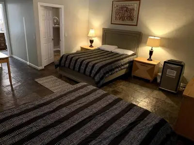 a bedroom with a bed and two tables and two lamps at PACIFIC BEACH ESTATE water view in San Diego