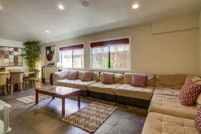 a living room with a couch and a table at PACIFIC BEACH ESTATE water view in San Diego