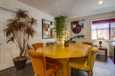 a dining room with a yellow table and chairs at PACIFIC BEACH ESTATE water view in San Diego