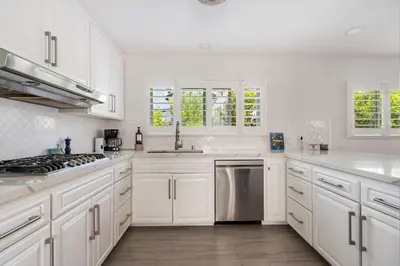 a white kitchen with white cabinets and a sink at Luxury La Jolla Home with Jacuzzi in San Diego