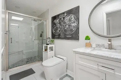 a bathroom with a shower and a toilet and a mirror at Luxury La Jolla Home with Jacuzzi in San Diego