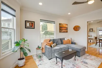 a living room with a couch and a table at Steps to Balboa Park Sunny Historic Apartment in San Diego