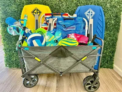 a cart full of beach items next to a suitcase at Majestic Views Pool&Jacuzzi, Mini Golf, Playground in Spring Valley