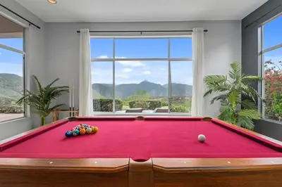a red pool table in a room with windows at Massive 7BR Stunning MTN View Zen Retreat Pool and Spa in Ramona