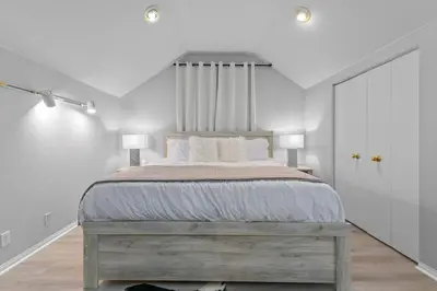 a bedroom with a large bed with white walls at Massive 7BR Stunning MTN View Zen Retreat Pool and Spa in Ramona