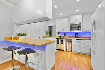 a kitchen with white cabinets and blue accents at Massive 5BR Resort Style Retreat with Heated Pool in San Diego