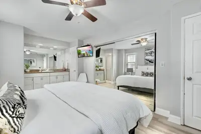 a white bedroom with a bed and a ceiling fan at MB Contemporary 14 Guests by Sand AC plus Garage in San Diego